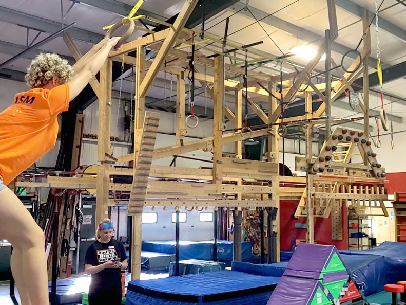 Alanis prepares to launch into the Ninja rings in indoor gym.
