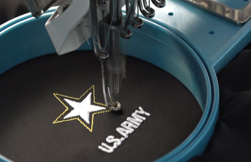 embroidery machine finishing the US Army logo on a jacket