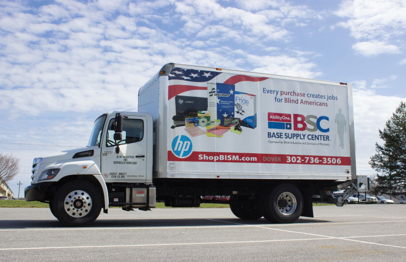 BSC truck with advertisement for the BSCs and ShopBISM.com on the side parked outside a store